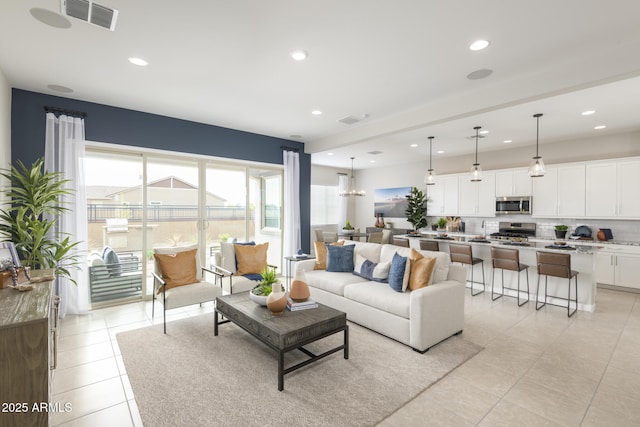 living room with sink and light tile patterned flooring