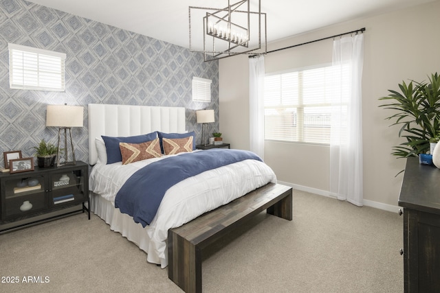 bedroom featuring an inviting chandelier and light carpet