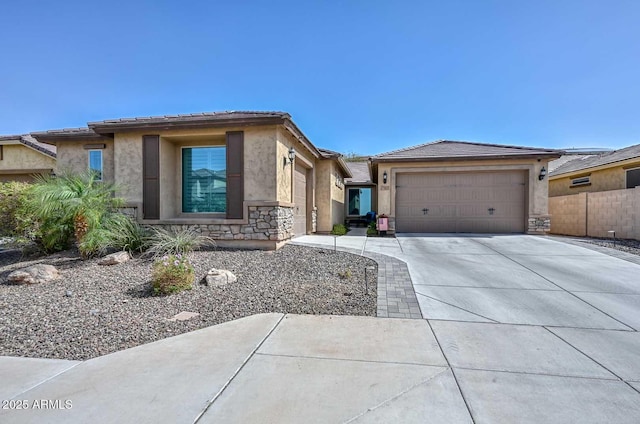 prairie-style house with a garage, stone siding, concrete driveway, and stucco siding