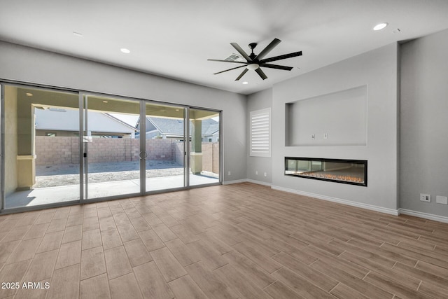 unfurnished living room featuring ceiling fan