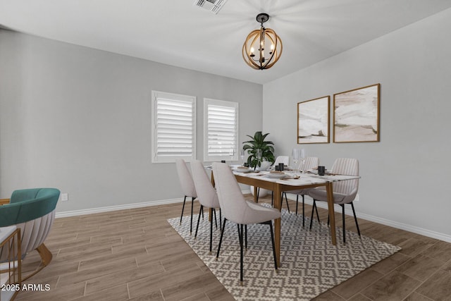 dining area featuring a notable chandelier