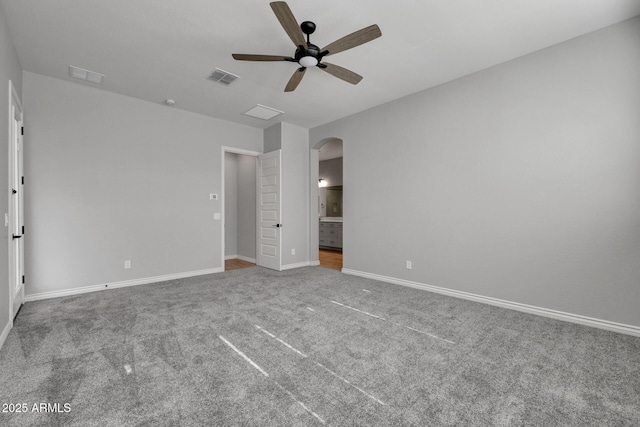 unfurnished bedroom with carpet, ceiling fan, and ensuite bath