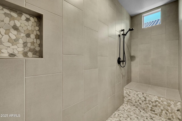 bathroom with a tile shower