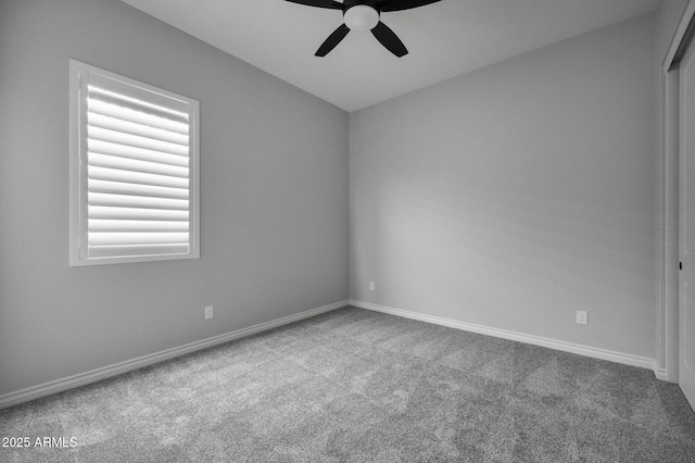 empty room with ceiling fan and carpet floors