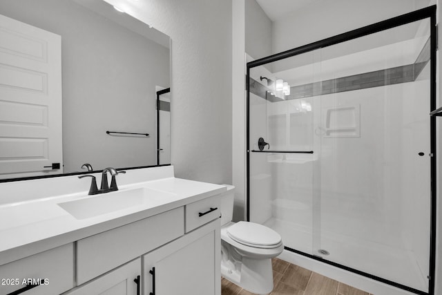 bathroom with vanity, toilet, and an enclosed shower