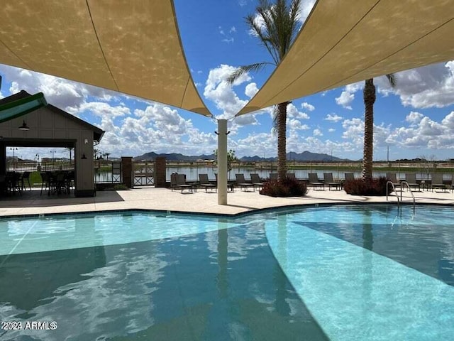 view of pool featuring a water and mountain view