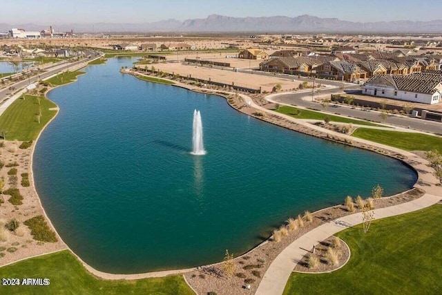 drone / aerial view with a water and mountain view