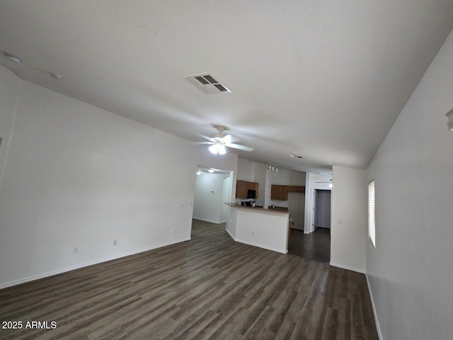 unfurnished living room featuring dark hardwood / wood-style flooring and ceiling fan