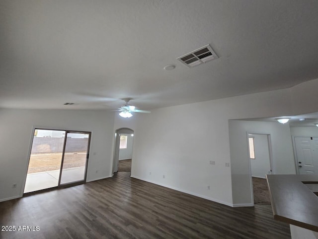 unfurnished room with dark wood-type flooring and ceiling fan