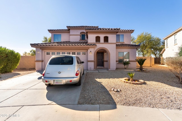 mediterranean / spanish house with a garage