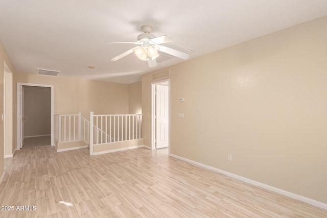 unfurnished room featuring ceiling fan and light wood-type flooring