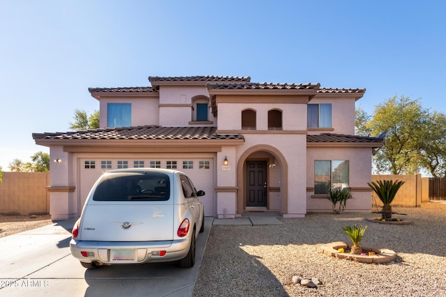 mediterranean / spanish home featuring a garage