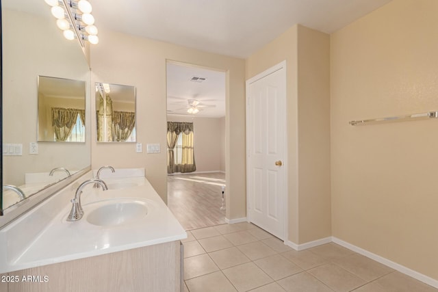 bathroom with vanity, ceiling fan with notable chandelier, and tile patterned floors