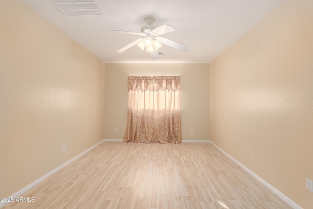 spare room featuring light wood-type flooring and ceiling fan