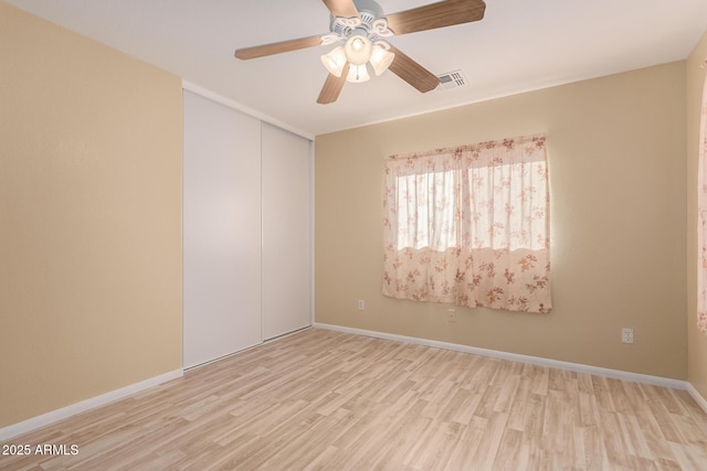 unfurnished room with ceiling fan and light hardwood / wood-style floors