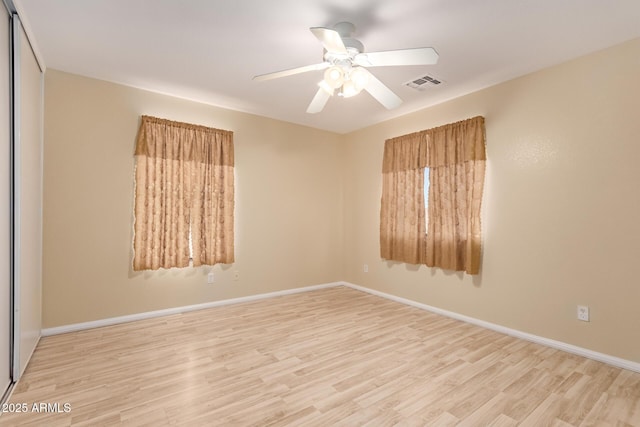 spare room featuring ceiling fan and light wood-type flooring