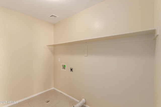 laundry area featuring hookup for an electric dryer, hookup for a washing machine, and light tile patterned floors