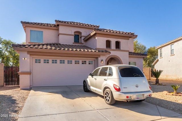 mediterranean / spanish-style house with a garage