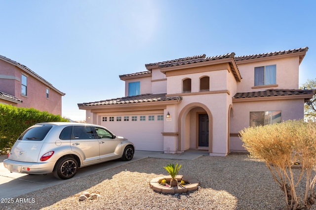 mediterranean / spanish house with a garage