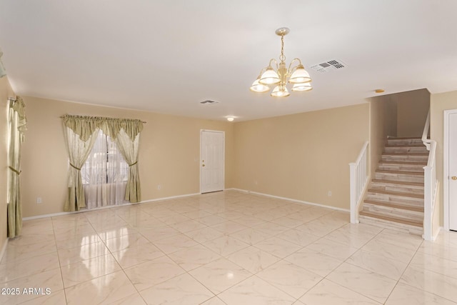 unfurnished room with a notable chandelier