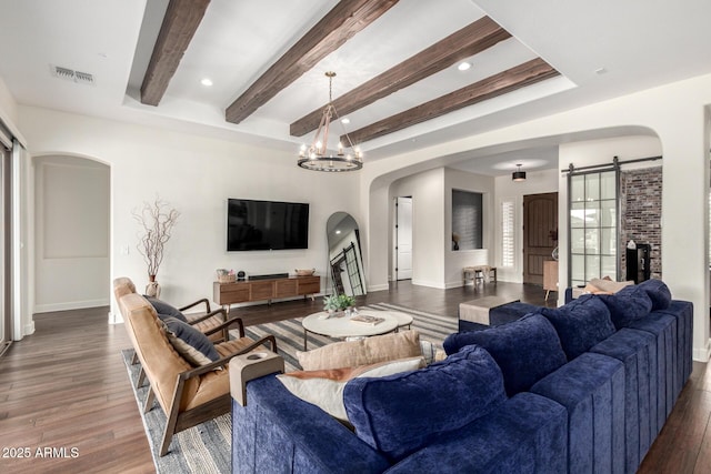 12834 W Forest Pleasant Pl, Peoria, AZ 85383 - living area with arched walkways, a barn door, beam ceiling, baseboards, and wood finished floors