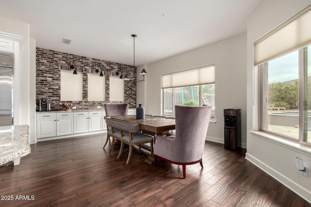12834 W Forest Pleasant Pl, Peoria, AZ 85383 - dining area featuring dark wood-type flooring and baseboards