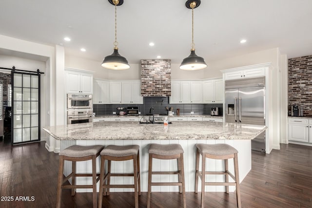 12834 W Forest Pleasant Pl, Peoria, AZ 85383 - kitchen with stainless steel appliances, a sink, decorative backsplash, white cabinetry, and recessed lighting