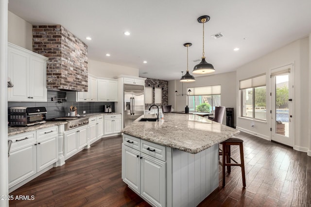 12834 W Forest Pleasant Pl, Peoria, AZ 85383 - kitchen with a sink, stainless steel appliances, dark wood-style floors, backsplash, and white cabinetry