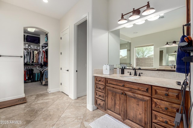 12834 W Forest Pleasant Pl, Peoria, AZ 85383 - full bath featuring vanity, baseboards, and a walk in closet