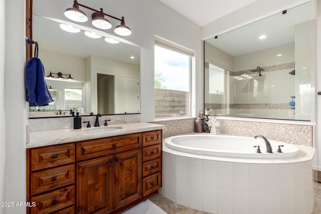 12834 W Forest Pleasant Pl, Peoria, AZ 85383 - bathroom featuring a tile shower, a garden tub, vanity, and healthy amount of natural light