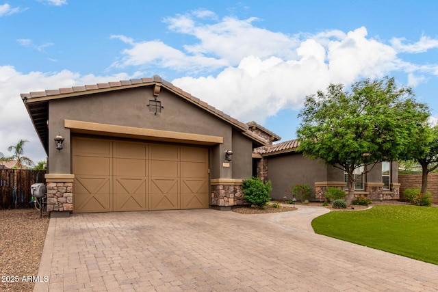 12834 W Forest Pleasant Pl, Peoria, AZ 85383 - view of front facade with stone siding, stucco siding, decorative driveway, a garage, and a tiled roof
