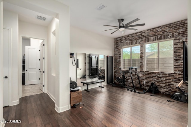 12834 W Forest Pleasant Pl, Peoria, AZ 85383 - exercise area with a ceiling fan, hardwood / wood-style flooring, brick wall, and baseboards