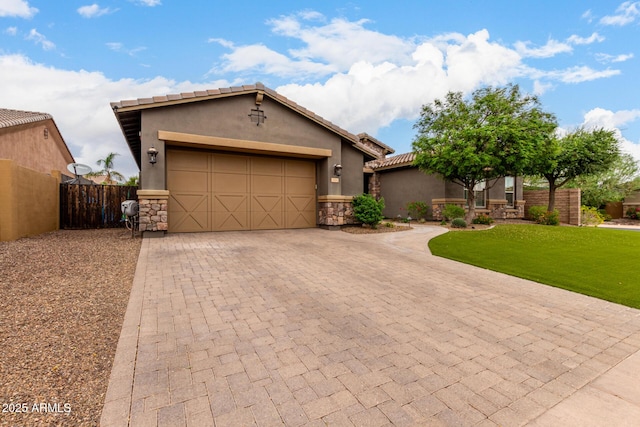 12834 W Forest Pleasant Pl, Peoria, AZ 85383 - view of front of property featuring decorative driveway, an attached garage, stucco siding, stone siding, and a tiled roof