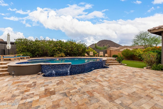 12834 W Forest Pleasant Pl, Peoria, AZ 85383 - view of swimming pool with a patio, a pool with connected hot tub, and a mountain view