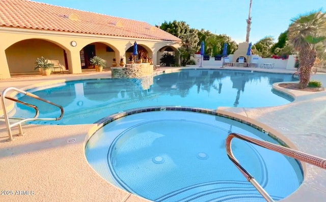 view of pool with a patio and a community hot tub