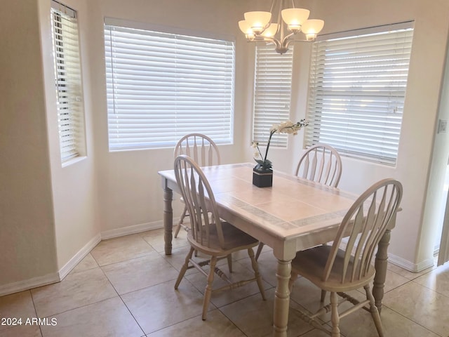 dining room featuring a notable chandelier, a wealth of natural light, and light tile patterned floors