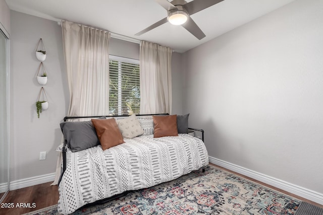 bedroom with ceiling fan and wood-type flooring