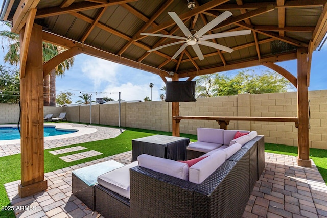 view of patio / terrace featuring a fenced in pool, ceiling fan, an outdoor living space, and a gazebo