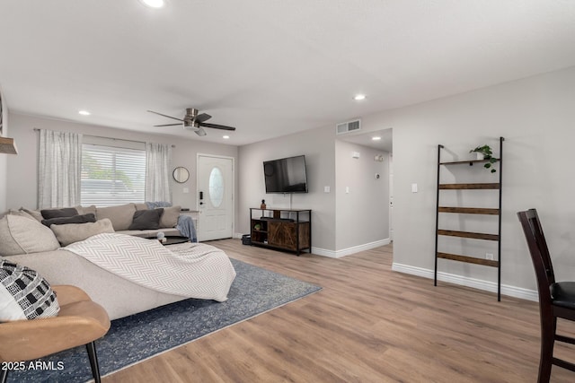 living room with hardwood / wood-style floors and ceiling fan