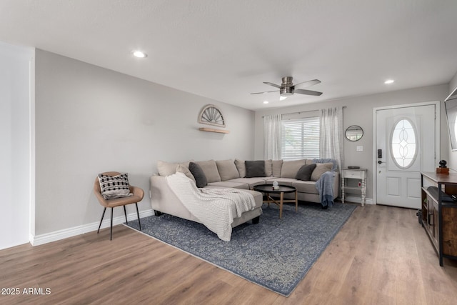 living room with ceiling fan and wood-type flooring