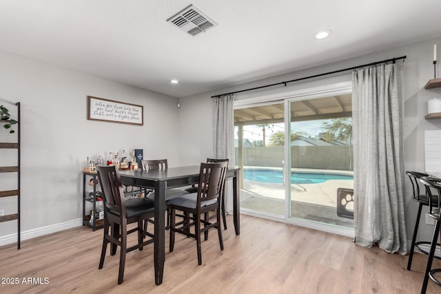 dining space with light hardwood / wood-style flooring