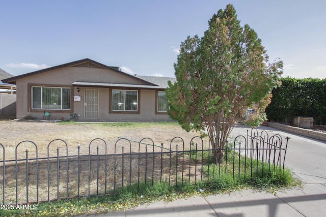 view of front of house featuring a fenced front yard and stucco siding