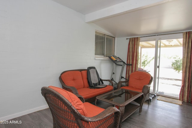 sitting room featuring a wealth of natural light, lofted ceiling with beams, baseboards, and wood finished floors