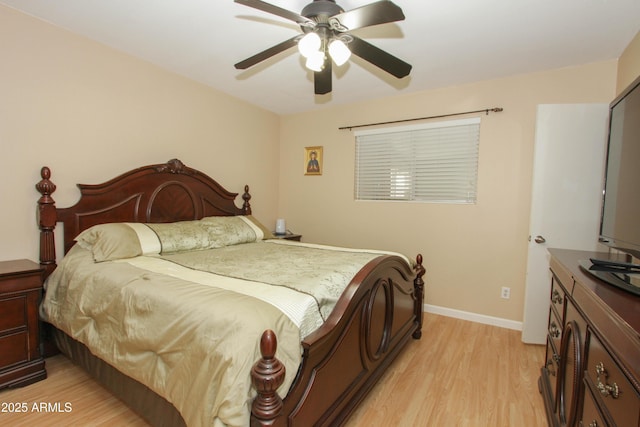 bedroom featuring baseboards, ceiling fan, and light wood finished floors