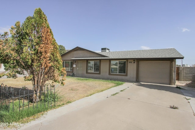 ranch-style house with an attached garage, central AC, fence, concrete driveway, and stucco siding