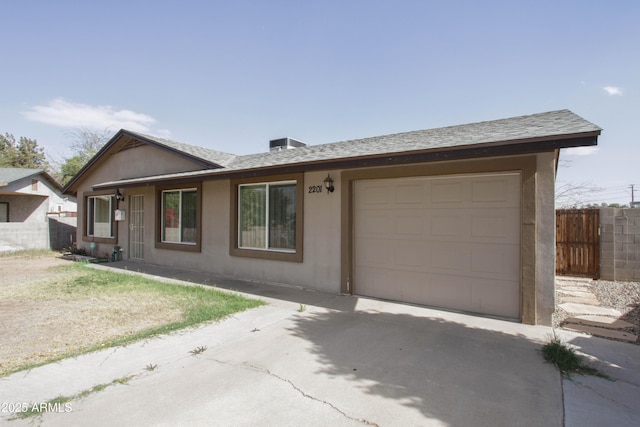 ranch-style house featuring a garage, driveway, fence, and stucco siding