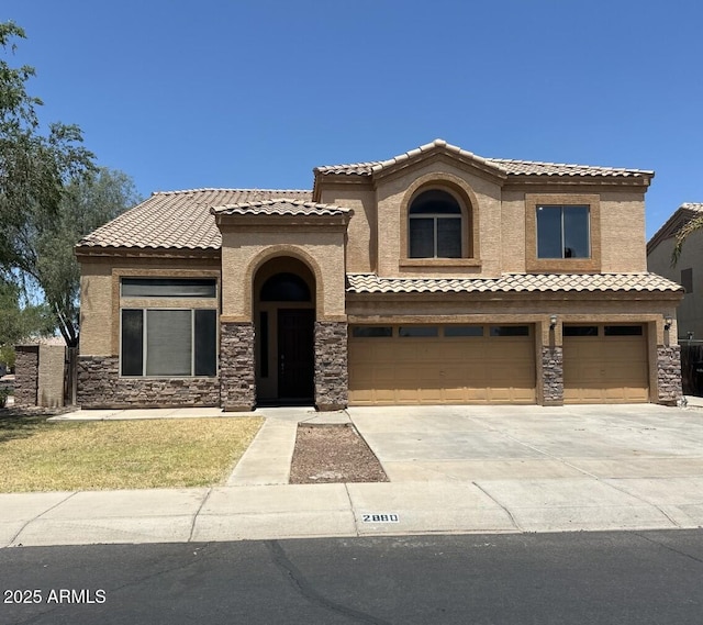 2880 E Nunneley Rd, Gilbert, AZ 85296 - mediterranean / spanish house featuring a tile roof, an attached garage, stone siding, and concrete driveway