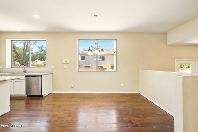 2880 E Nunneley Rd, Gilbert, AZ 85296 - unfurnished dining area featuring dark wood-style flooring, a chandelier, a sink, baseboards, and recessed lighting