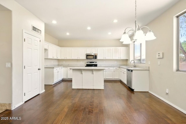 2880 E Nunneley Rd, Gilbert, AZ 85296 - kitchen featuring stainless steel appliances, a sink, a chandelier, dark wood-style floors, and white cabinetry