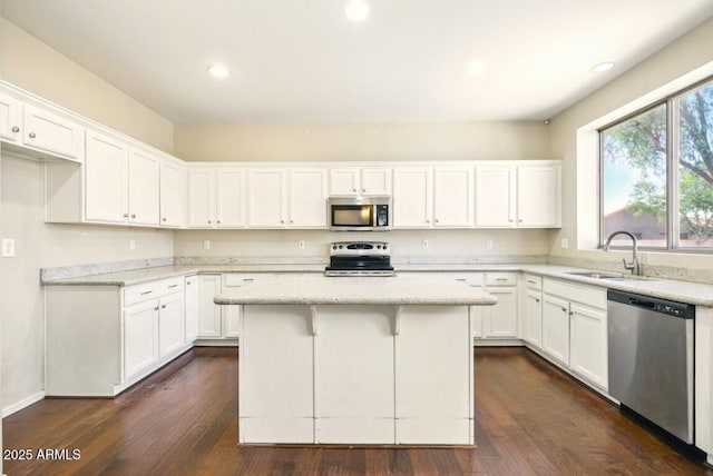 2880 E Nunneley Rd, Gilbert, AZ 85296 - kitchen featuring appliances with stainless steel finishes, a sink, white cabinets, a center island, and dark wood-type flooring